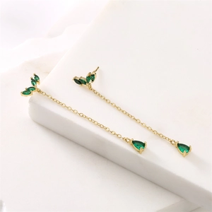Detail of gold-plated tassel earrings with green zircon marquise and pear charms