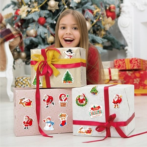 Girl smiling with colorful holographic Christmas stickers on festive gift boxes