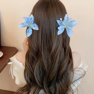 Set of two sky blue hibiscus flower hair clips on model back view for summer vacation