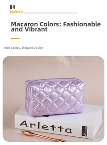 Detail of purple quilted makeup bag with satin finish and diamond stitch pattern