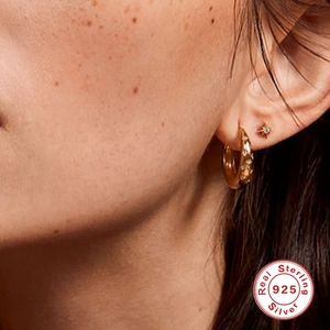 Classic S925 sterling silver gold-plated star hoop earrings worn on model's ear