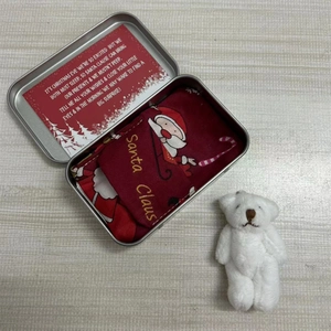 Christmas gift set featuring a white plush teddy bear with a Santa Claus tin box