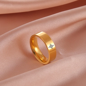 Gold stainless steel wide ring with black witch knot pattern on pink silk background