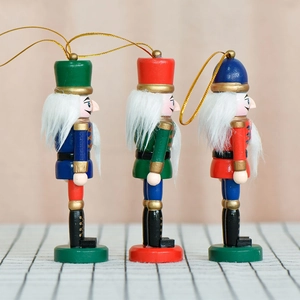 Three 13cm wooden nutcracker ornaments in red, green and blue for Christmas tree decor