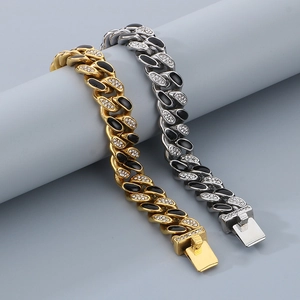 Close-up of gold and silver Cuban link bracelets with black enamel and white rhinestones