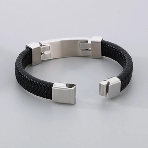 Close-up of black braided leather strap and brushed stainless steel magnetic buckle