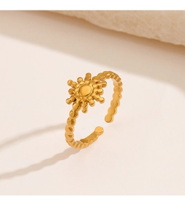 Detailed close-up of 18K gold plated sun motif ring with beaded texture and open band