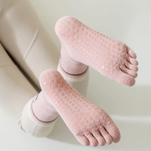 Pink five-toe yoga socks featuring non-slip silicone grippers and athletic embroidery
