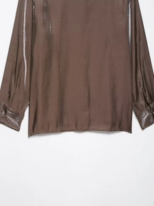 Detailed macro shot of dark brown satin shirt showing smooth silky texture and metallic luster