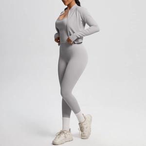 Detail of light gray yoga set featuring zip jacket, tank top, and high-waist leggings