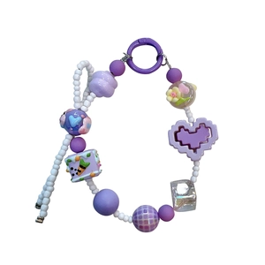 Handmade purple beaded phone strap featuring a pixel heart and floral charms for bags