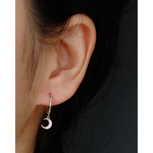 Close-up of S925 sterling silver crescent moon hoop earring with sparkling zirconia stones