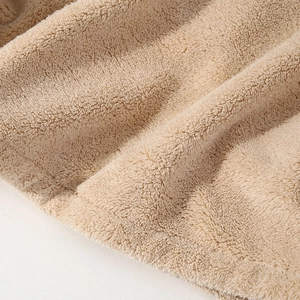 Macro shot showing the soft, thickened coral fleece texture of the quick-dry hair towel