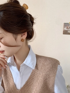 Close-up of amber translucent resin earrings on model with warm vintage aesthetic