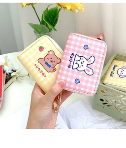 Close-up of cute cartoon bear and rabbit patterned plaid card holders with zipper