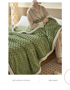 Detailed close-up of soft moss green bubble textured plush blanket with breathable fabric