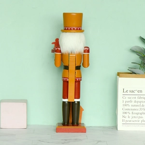 Back view of wooden Nutcracker chef with gingerbread house detail for Christmas decor