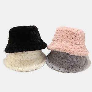 Detail of plush faux fur bucket hats showing thick textured fabric in multiple colors