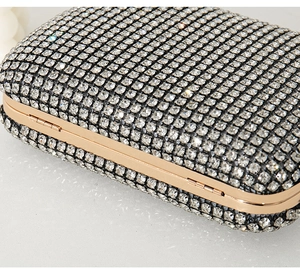 Close-up of sparkling crystals and golden metal frame on a luxury evening clutch bag