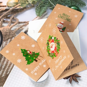 Close-up of kraft paper Christmas cards with festive patterns and Merry Christmas text