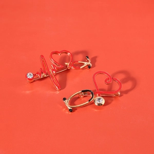 Red stethoscope enamel pin with heartbeat design and sparkling rhinestone accent