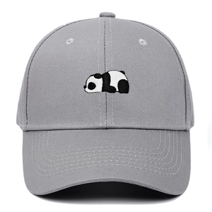 Close-up of a panda embroidery on a dark grey cotton baseball cap with fine texture