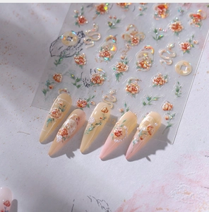 Detailed view of 3D embossed floral nail stickers with gold snake and coin patterns