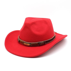 Detail of red wool felt cowboy hat with brown leather band and golden feather ornament