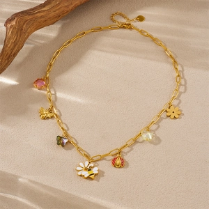 Garden themed gold-plated jewelry set with enamel bee, ladybug and flower charms on sand