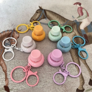 Set of colorful mini fidget button keychains in six pastel colors on patterned fabric