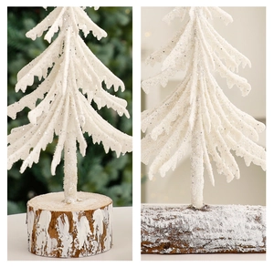 Detail of mini flocked cedar trees with rustic wooden bases and snowy finish textures