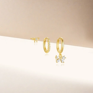Three-piece gold S925 silver earring set featuring bow design and sparkling crystals