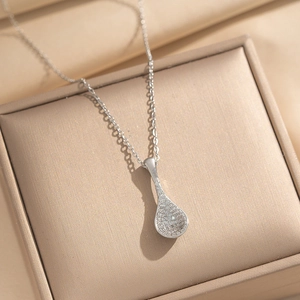 Sparkling teardrop pendant necklace with pavé diamonds on premium satin background