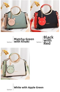 Three leather handbags with gold metal handles and cat charms in various color schemes