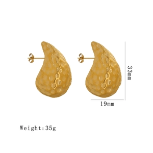 Gold teardrop earrings with hammered texture measuring 33mm in height and 19mm in width
