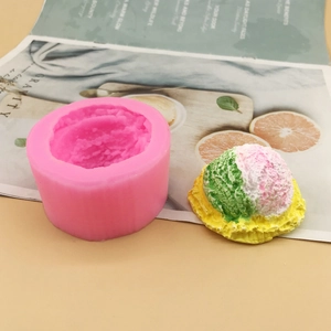 Pink silicone ice cream mold with colorful mousse scoops on decorative background
