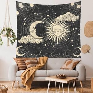 Bohemian sun and moon celestial tapestry hanging above a modern sofa in a room