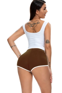 Rear view of women's white racerback tank top and brown athletic shorts with white trim