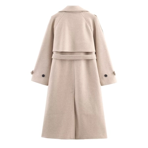 Back view of beige wool coat featuring wind flap, waist belt, and hem slit detail