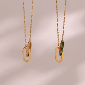 Golden necklace featuring dual oval pendants with white zircon and green gemstone settings