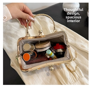 Detail view of the spacious interior lining and elegant metal handle of the vintage handbag