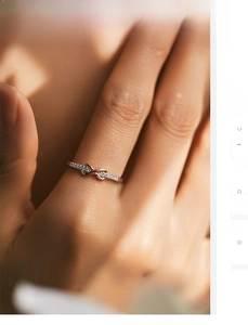 Macro shot of silver infinity ring with rose gold accents and sparkling crystal pavé