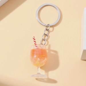 Detailed view of a mini glow cocktail cup keychain with fake ice and a striped straw