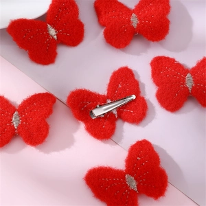Close-up of red felt butterfly hair clips with durable metal duckbill clips for girls