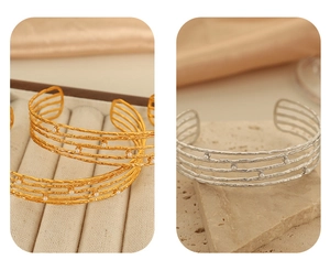 Close-up of four-layer C-shaped cuff bracelets with hammered texture and pearl accents