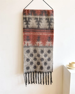 Detailed texture of ethnic geometric patterns and tassels on a thick autumn winter scarf