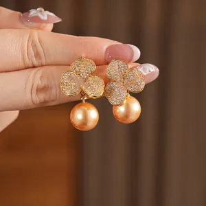 Gold plated petal earrings with sparkling cubic zirconia and champagne pearl pendants