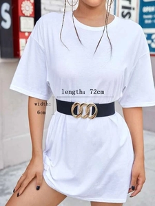 Detail of 6cm wide black elastic waist belt with gold interlocking metal buckle on a white tee