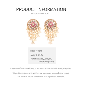 Detail view of gold alloy earrings with acrylic pink petals and pearl tassels details