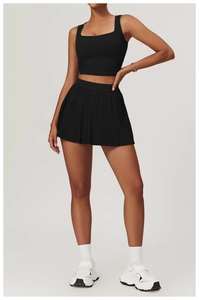 Close-up of black breathable athletic set featuring square neck tank top and pleated skirt